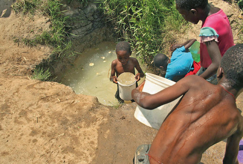 Figur 2  Barn henter vann fra en br&oslash;nn i Harare, desember 2008. Foto AP/Scanpix