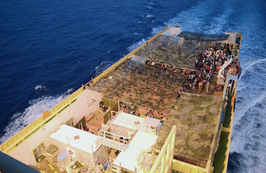 The holding area for migrants on the quarterdeck. To the fore (bottom left of the picture) is shown the treatment area for&hellip;